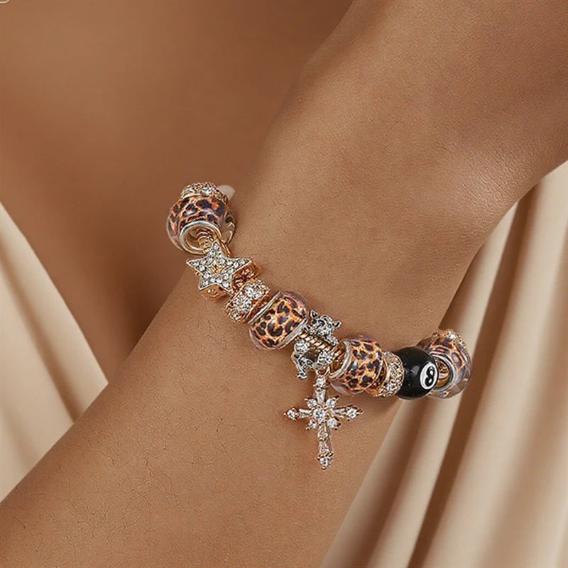 A close-up of a leopard print and black beaded bracelet worn on a wrist.