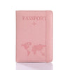 A pink leather passport organizer with a dove design and card slots.