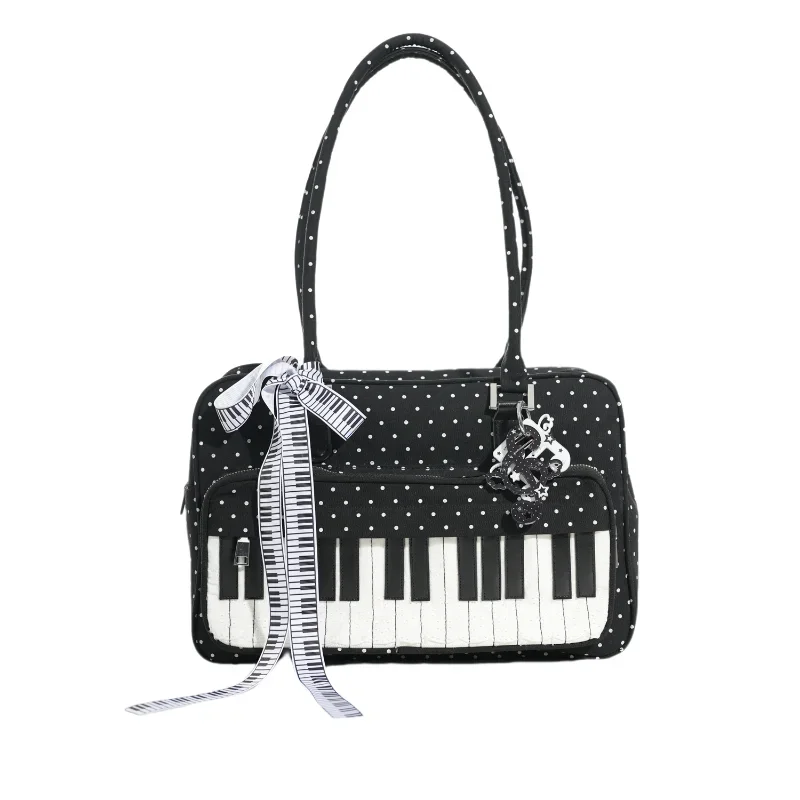 Black and white piano print crossbody bag featuring a musical note embroidery charm