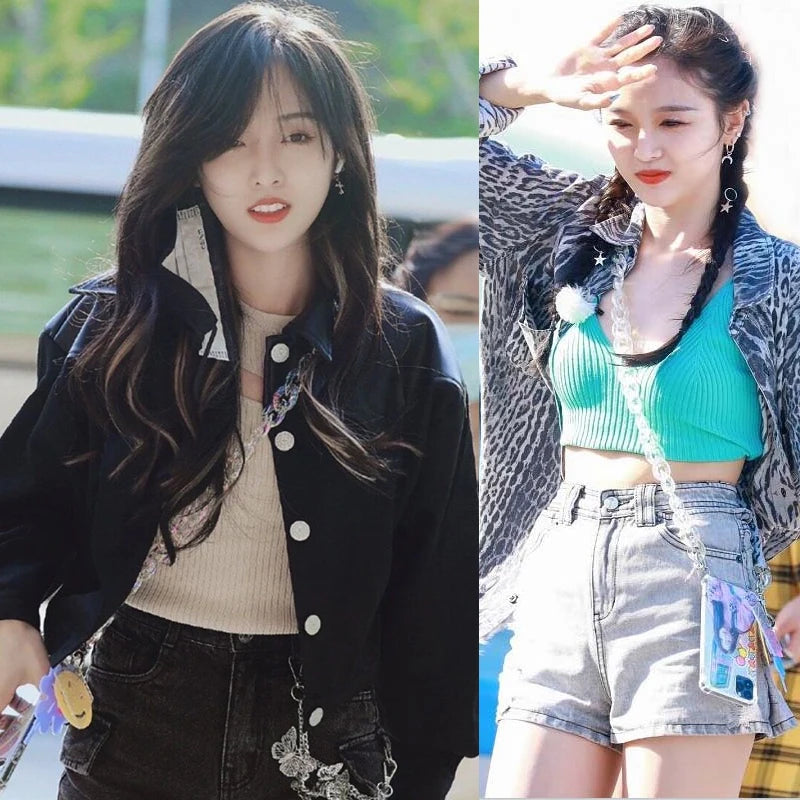 A young woman models an iridescent acrylic chunky chain strap for a bag, wearing a black jacket and denim shorts.