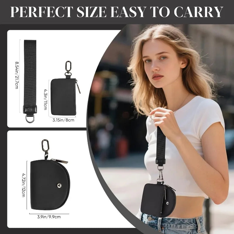 A woman holds a black dual zip keychain wallet wristlet in her hand.