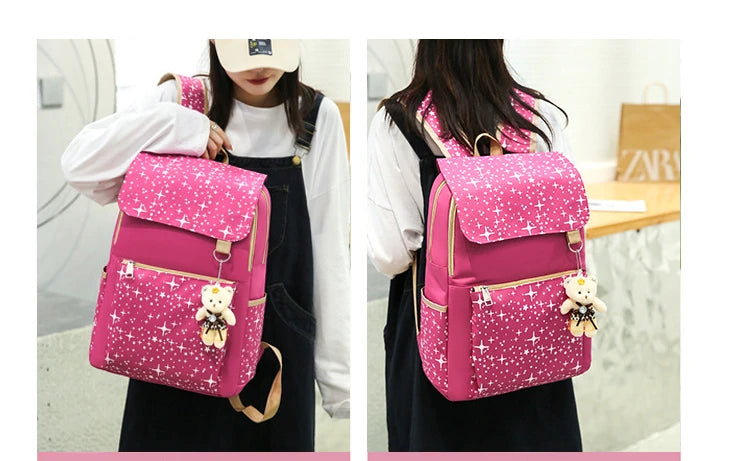 A pink sparkly canvas student backpack with a bear charm worn by a woman.