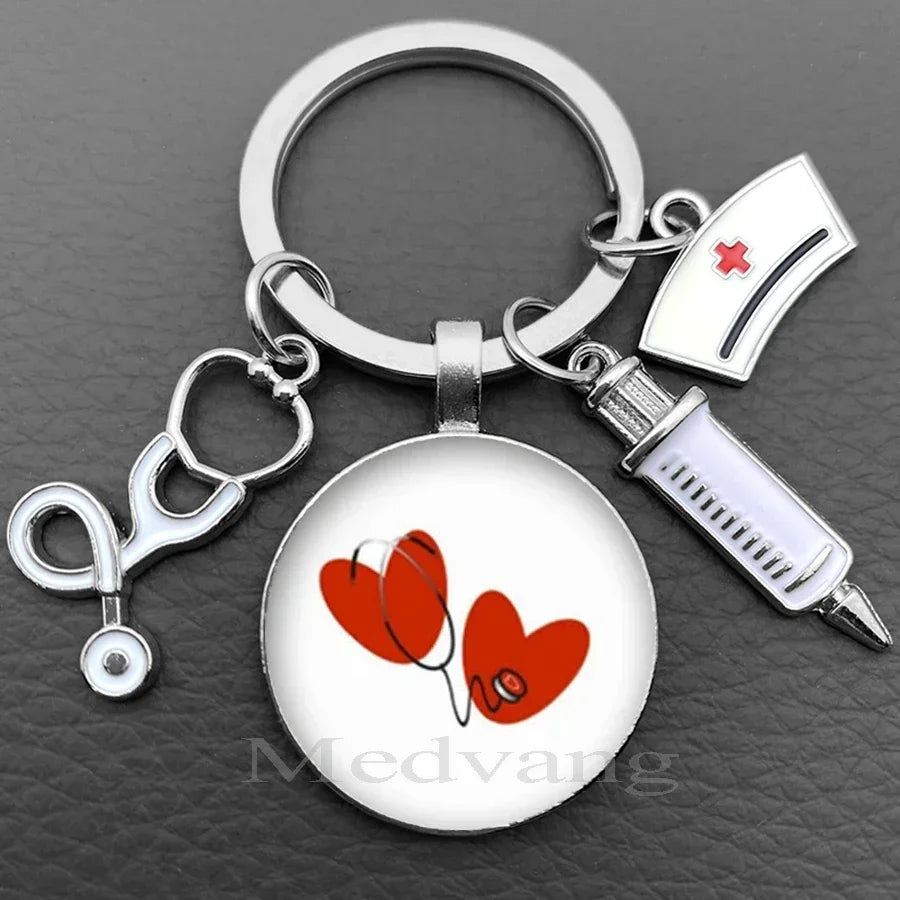 Silver keychain featuring a heart design with a stethoscope and a medical syringe charm