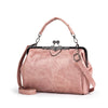 A light pink leather crossbody shoulder bag with a chain strap and gold hardware.