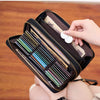 A close-up of a black leopard print RFID-blocking tri-fold wallet with a wrist strap, showing various cards inside.