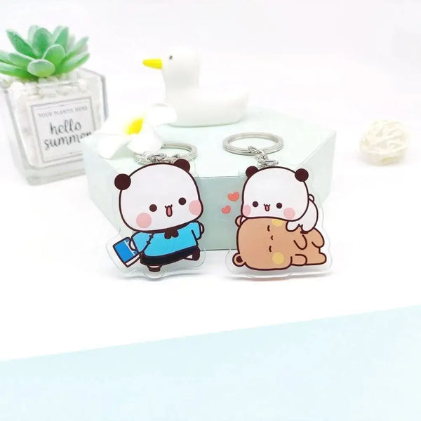 A set of cute Bubu Dudu cartoon resin keychain charms featuring a panda and a bear, displayed on a white box.