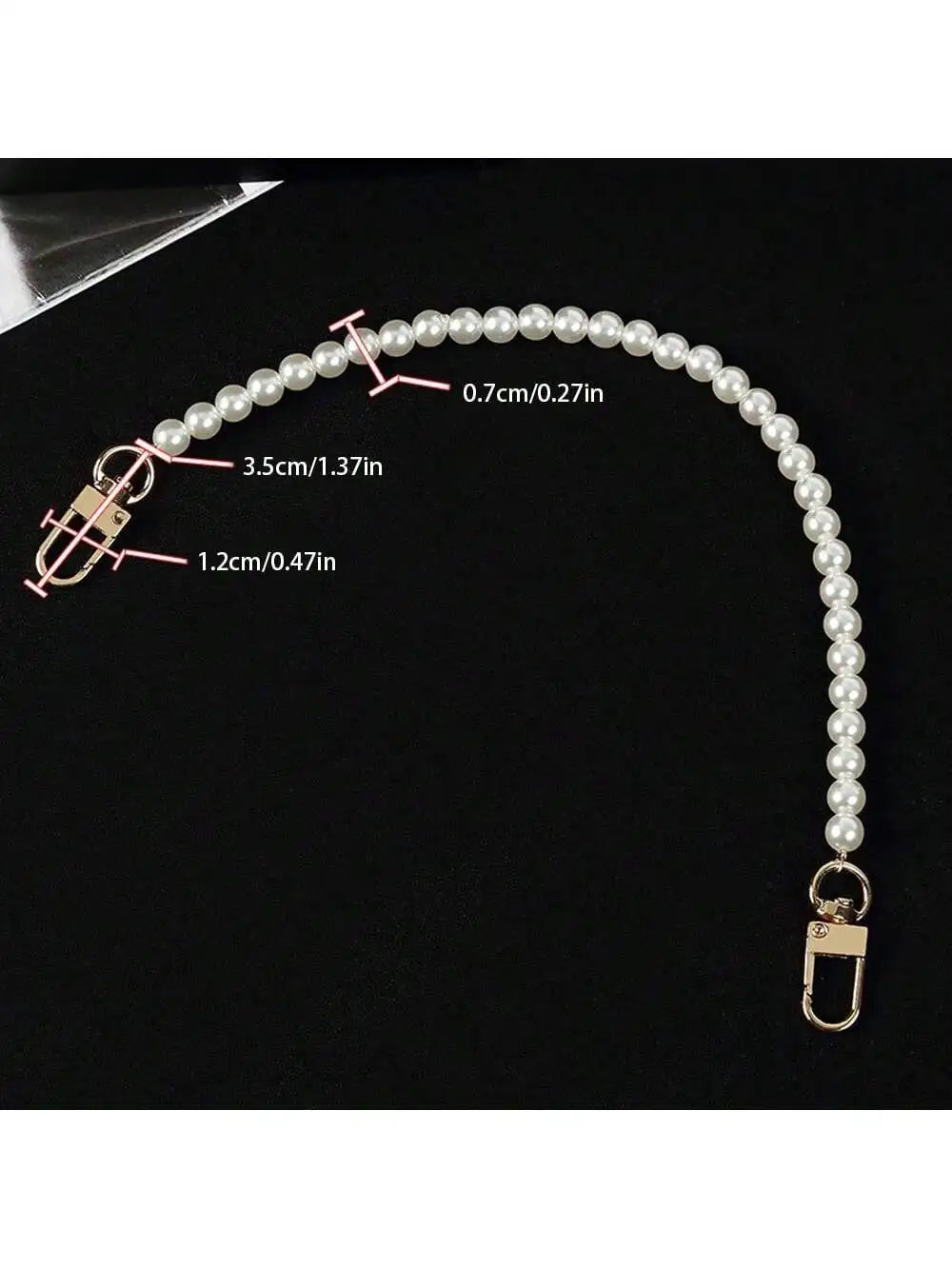 A delicate pearl strap for handbags showing various lengths and a clasp.