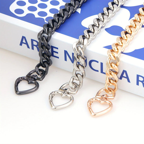 Three heart-shaped metal purse chains in black, silver, and gold displayed on a white background.