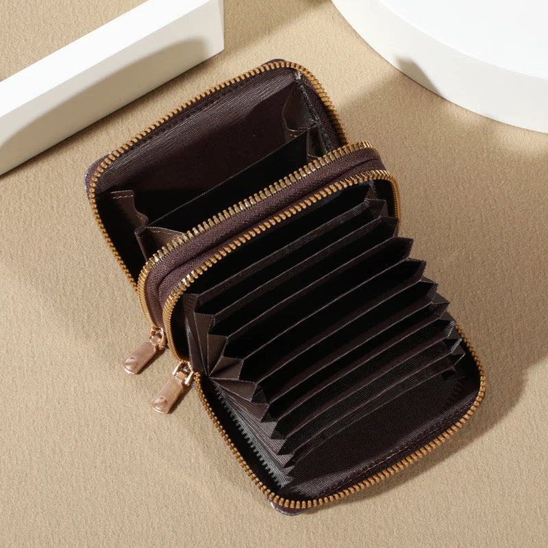 A dark brown vintage zippered card holder wallet shown open on a beige surface.