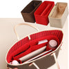 A brown felt purse organizer with red and beige inserts for storing small items like pens and cosmetics.