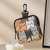 A black fabric coin purse featuring a pattern of various cute cats in shades of brown, gray, and white.
