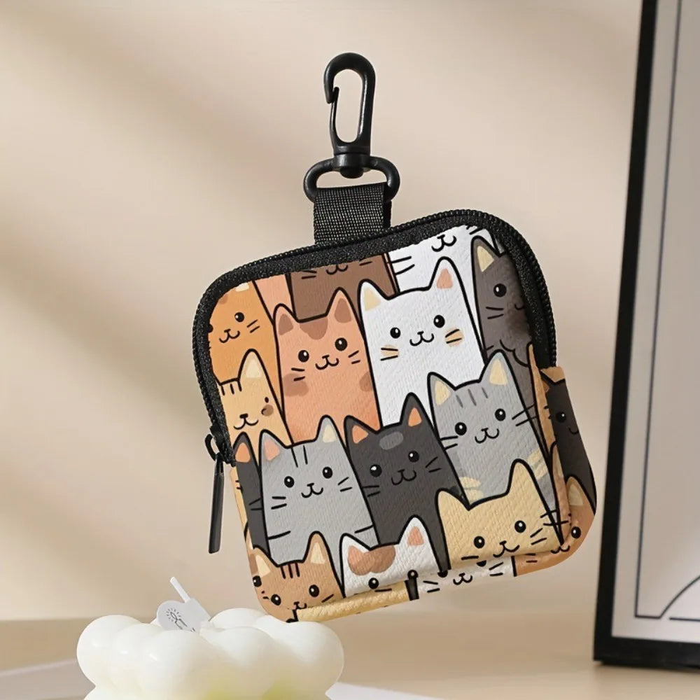 A black fabric coin purse featuring a pattern of various cute cats in shades of brown, gray, and white.