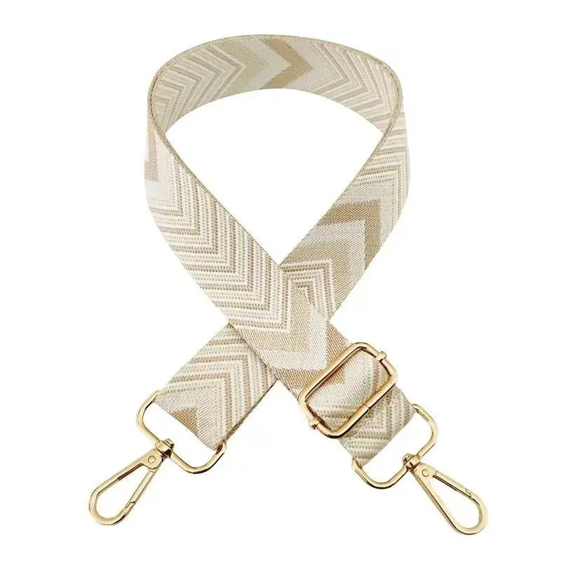A beige woven nylon strap with a chevron pattern used as an adjustable bag strap.