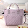 A light purple insulated lunch bag with a quilted texture and handles is shown on a wooden surface.