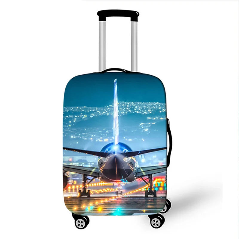 A silver suitcase with a blue cityscape and waterfall design is shown on wheels.