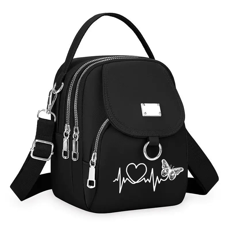 Sac bandoulière floral noir durable avec fermeture éclair et motif cœur.