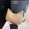 A beige PU leather shoulder bag with a gold zipper and strap is shown against a dark background.
