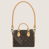 A brown synthetic leather handbag with a matching adjustable strap, featuring a dark brown monogram pattern.