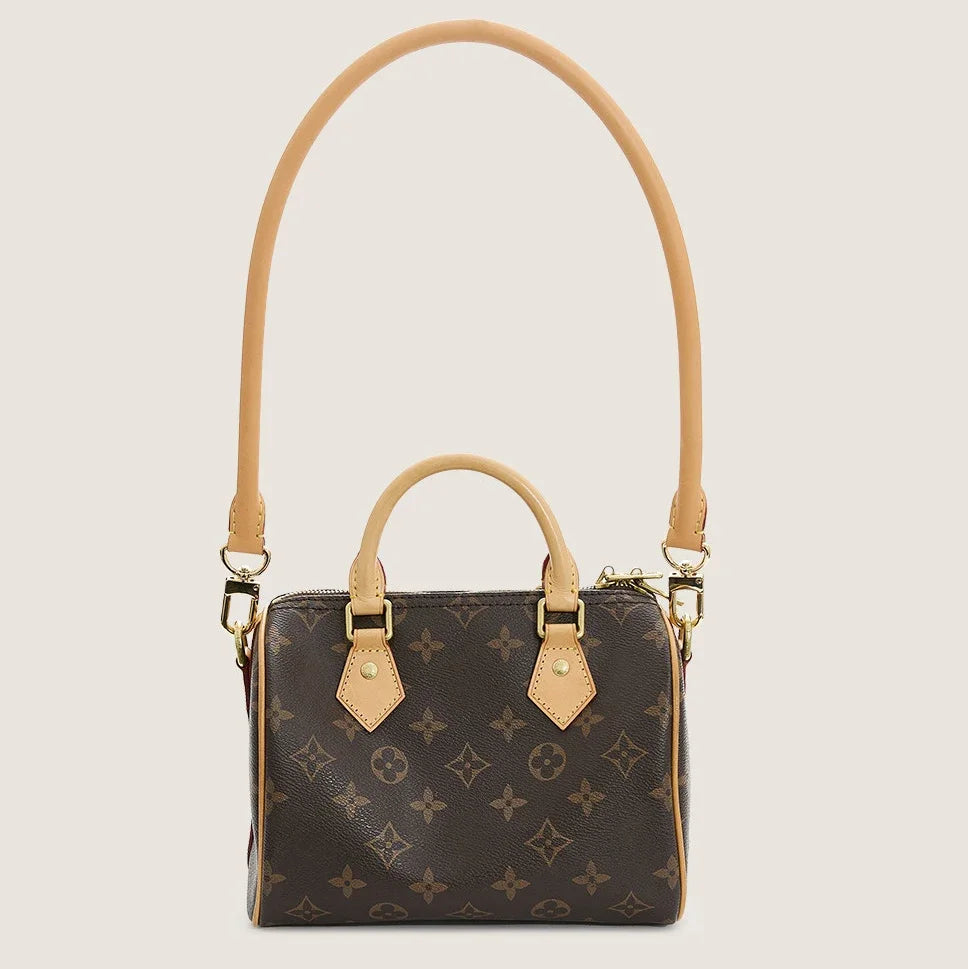A brown synthetic leather handbag with a matching adjustable strap, featuring a dark brown monogram pattern.