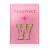A pink leather passport holder with the word W embossed in glitter and a pink airplane design.