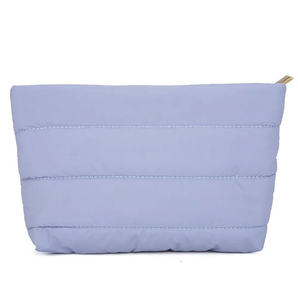 Light purple quilted cosmetic travel bag with a zipper closure