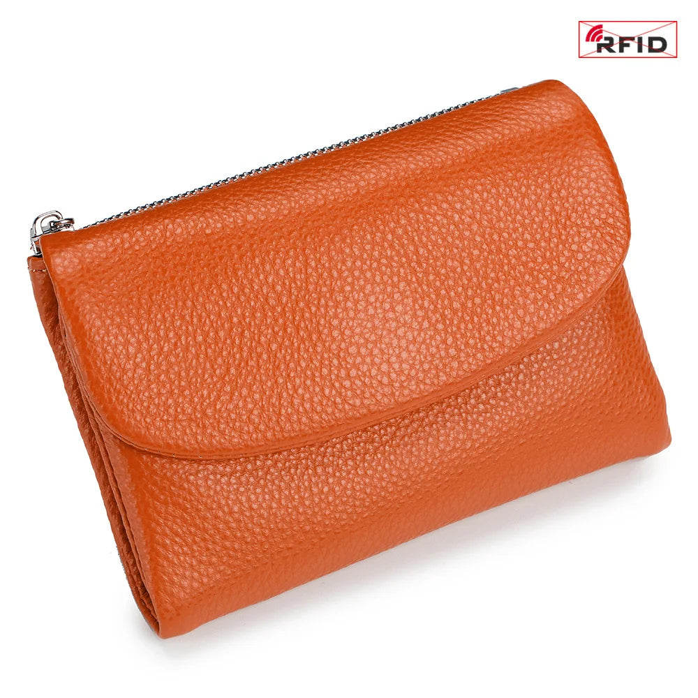 An orange genuine leather mini card holder wallet with a zipper closure.