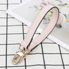 A light pink genuine leather replacement shoulder strap with a gold-toned buckle is displayed on a black and white checkered 