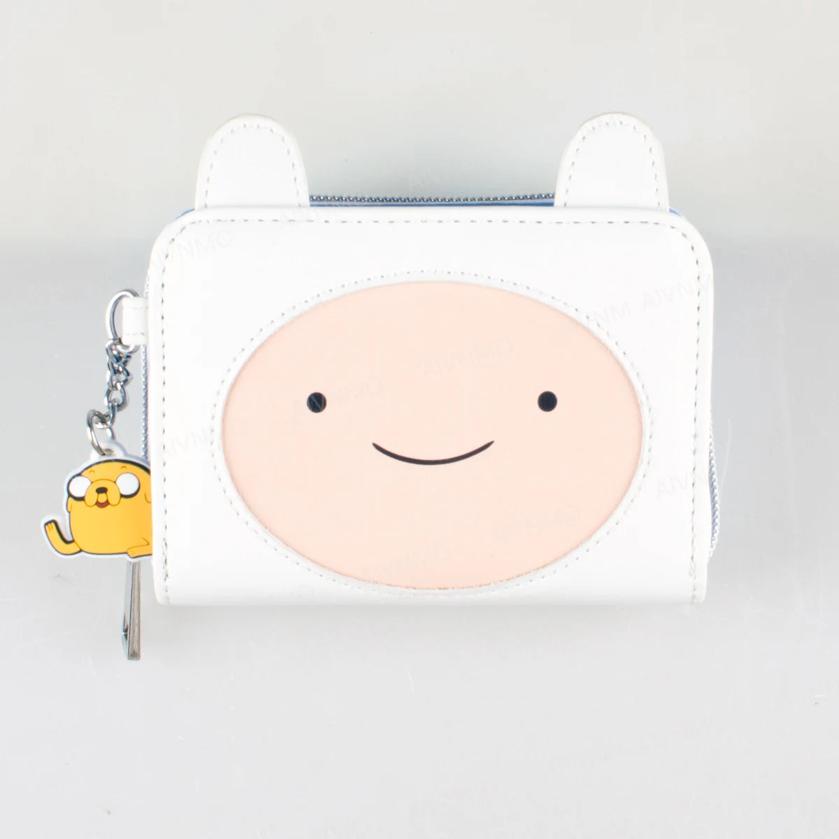 A white leather wallet featuring a round, smiling face design and a yellow charm.