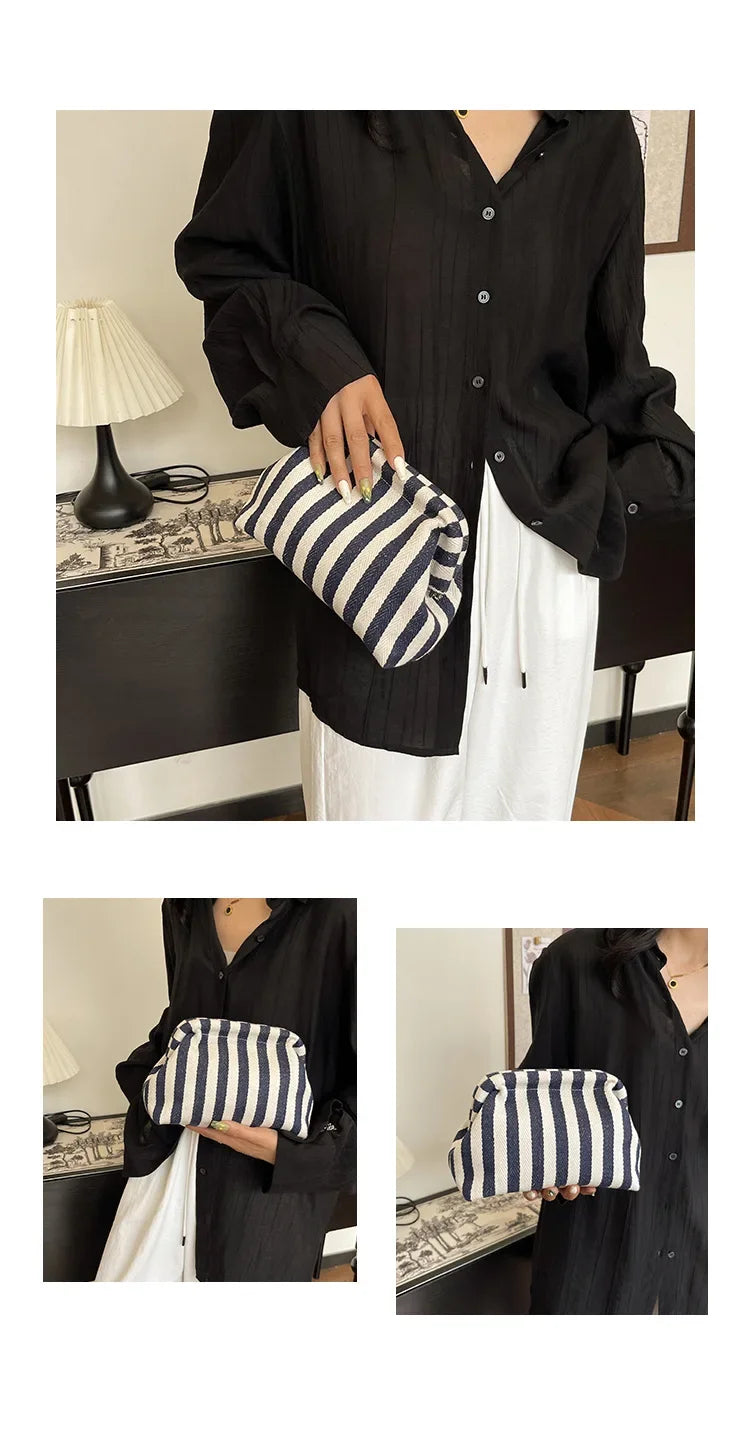 A woman holds a black striped crochet tote bag with a shell accent against a dark background.