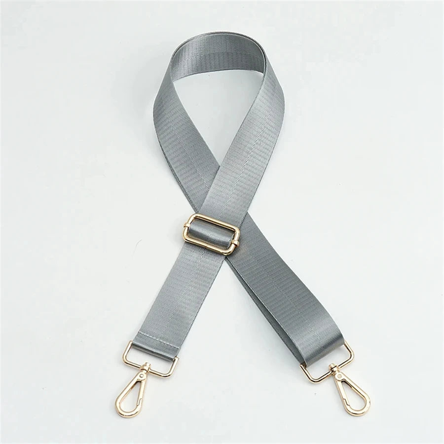 A gray nylon adjustable shoulder strap with a gold buckle and metal clasps.