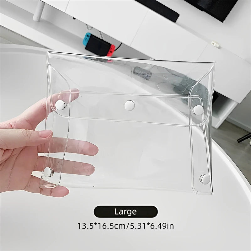 A hand holds a clear transparent portable organizer pouch for cosmetics and tools, labeled as large.