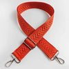 Orange woven strap with an arrow jacquard pattern shown in an 'X' shape