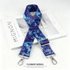A dark blue patterned nylon strap with a silver buckle is displayed on a white box.