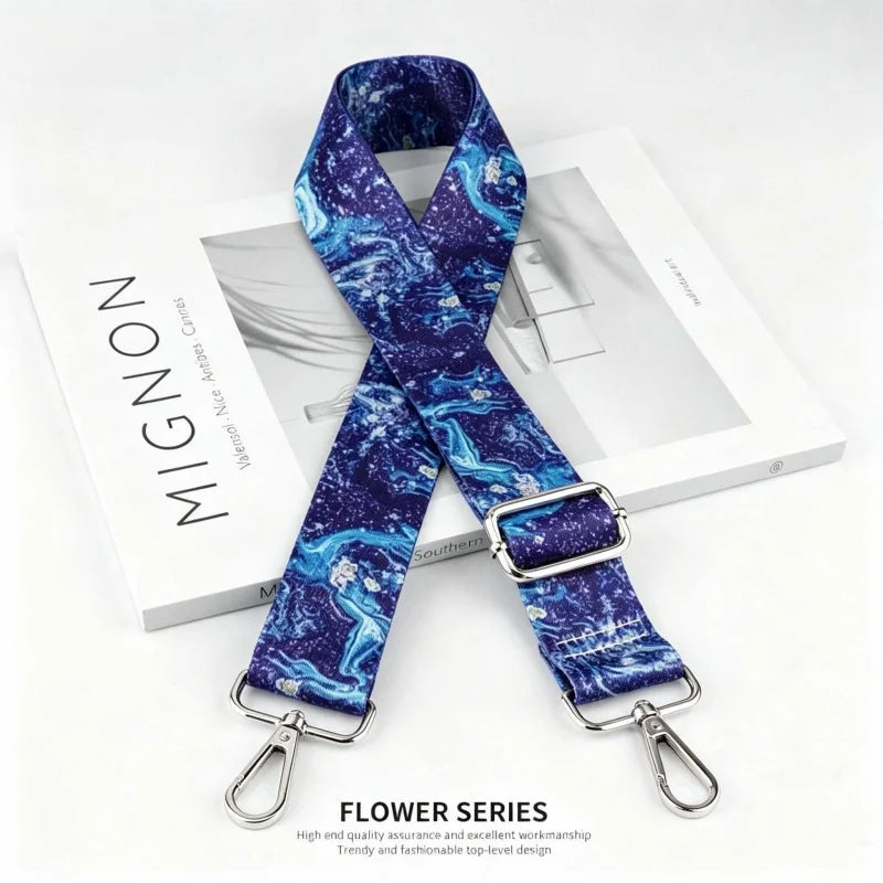 A dark blue patterned nylon strap with a silver buckle is displayed on a white box.