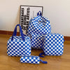 A blue and white checkerboard multi-pocket backpack displayed on a wooden surface.