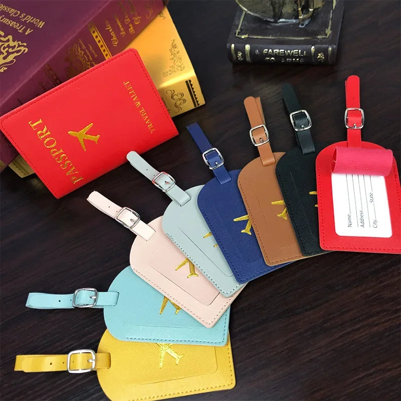 A collection of red, yellow, and black PU leather passport holders with card slots arranged on a dark surface.