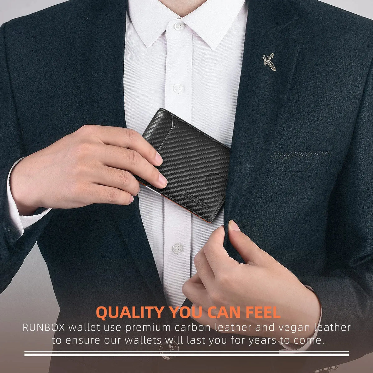A hand is holding a black carbon leather wallet inside a dark suit jacket pocket.