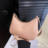 A light pink retro solid color PU leather shoulder bag with a tan strap shown against a dark background.