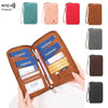 A brown leather passport and document holder is shown open, displaying various passports and cards, with several colored RFID