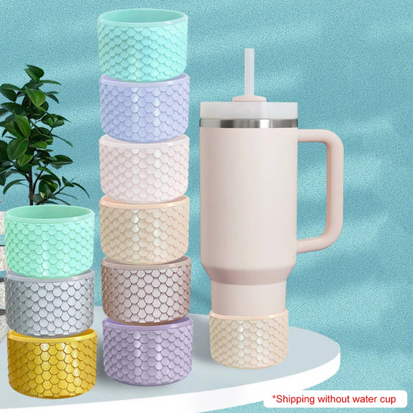 A stack of colorful silicone boot sleeves in various shades of green, purple, and pink next to a pink insulated water bottle.