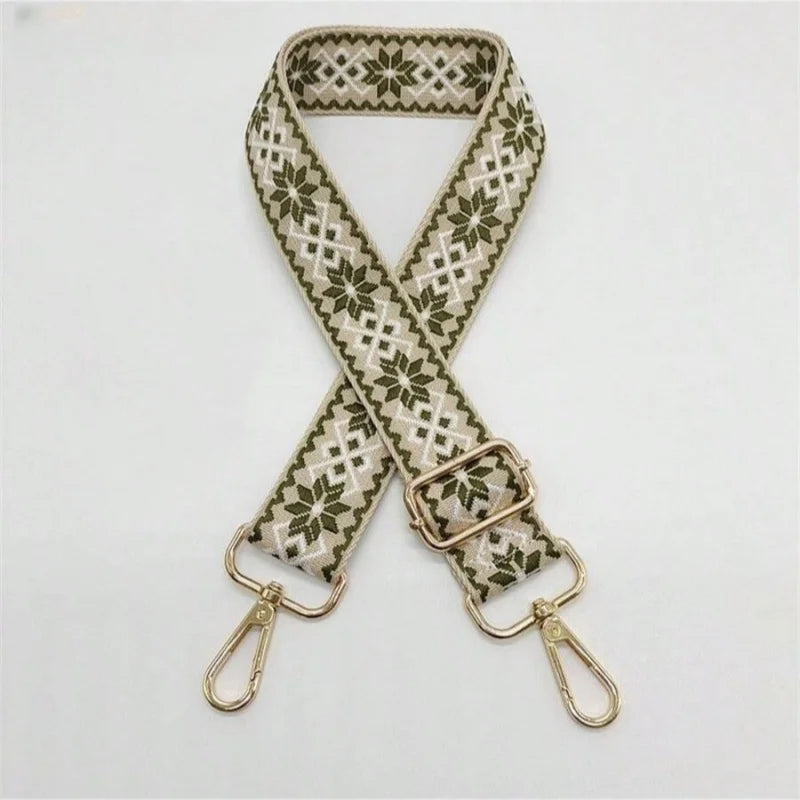 A beige and olive green patterned replacement bag strap with adjustable metal clasps.