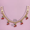 Gold alloy necklace featuring a chain with small red cherry flower bag pendants.