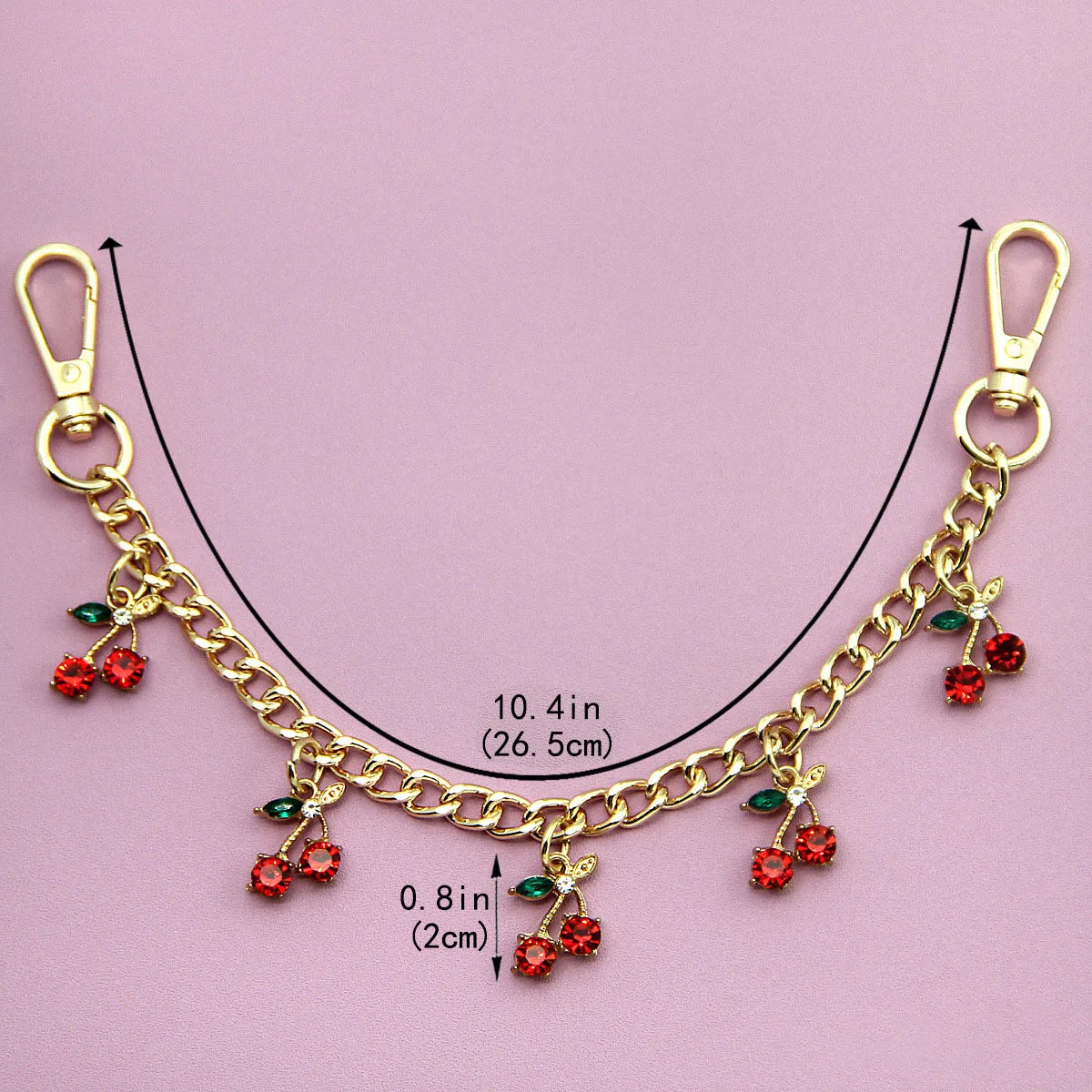 Gold alloy necklace featuring a chain with small red cherry flower bag pendants.