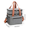 Bolso térmico gris para picnic con correas naranjas y bolsillo frontal con cremallera.