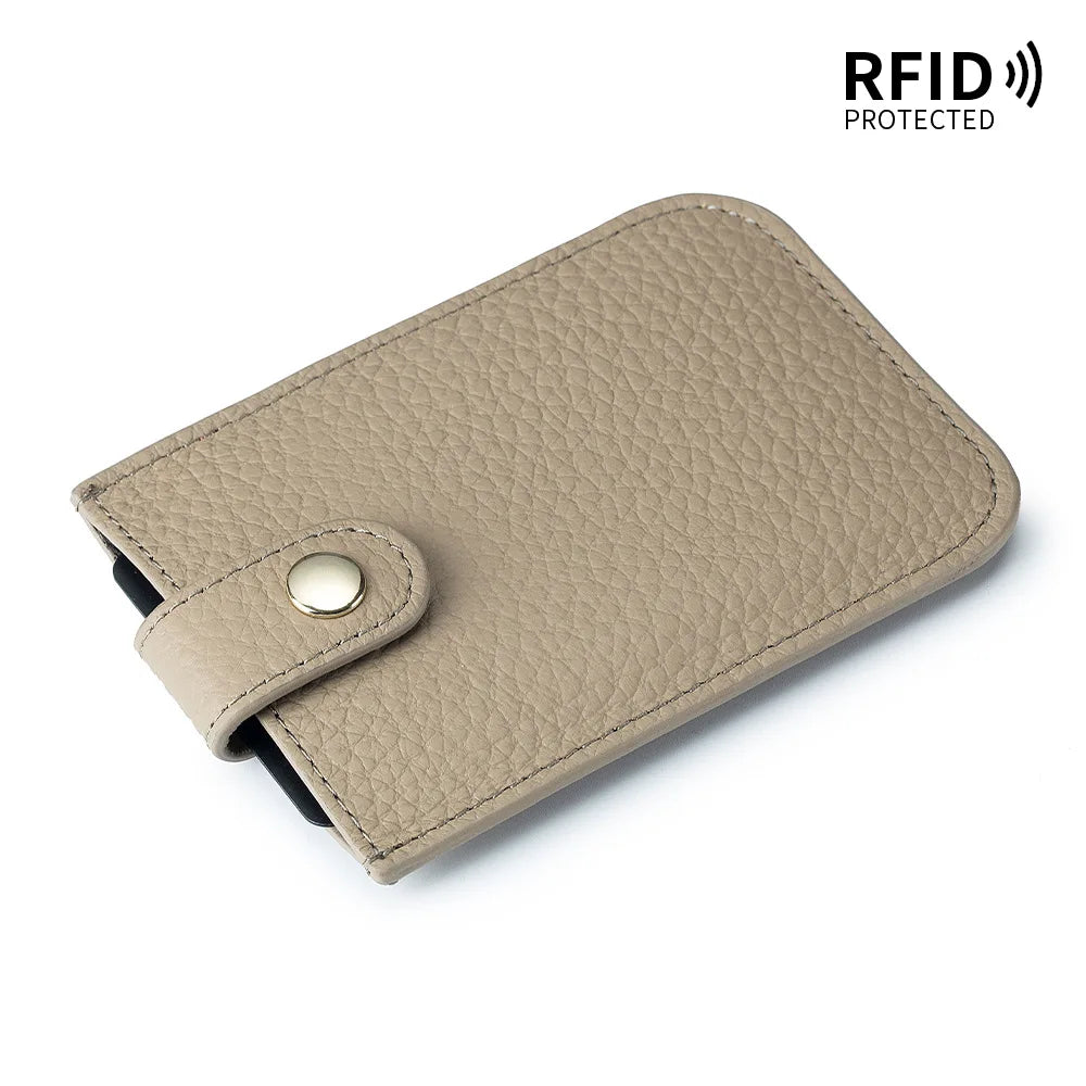 A beige genuine leather slim card holder with a stitched texture and a leather flap closure.