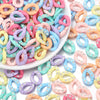 A pile of colorful acrylic link chains in various shades of pink, purple, blue, and yellow for DIY jewelry making.