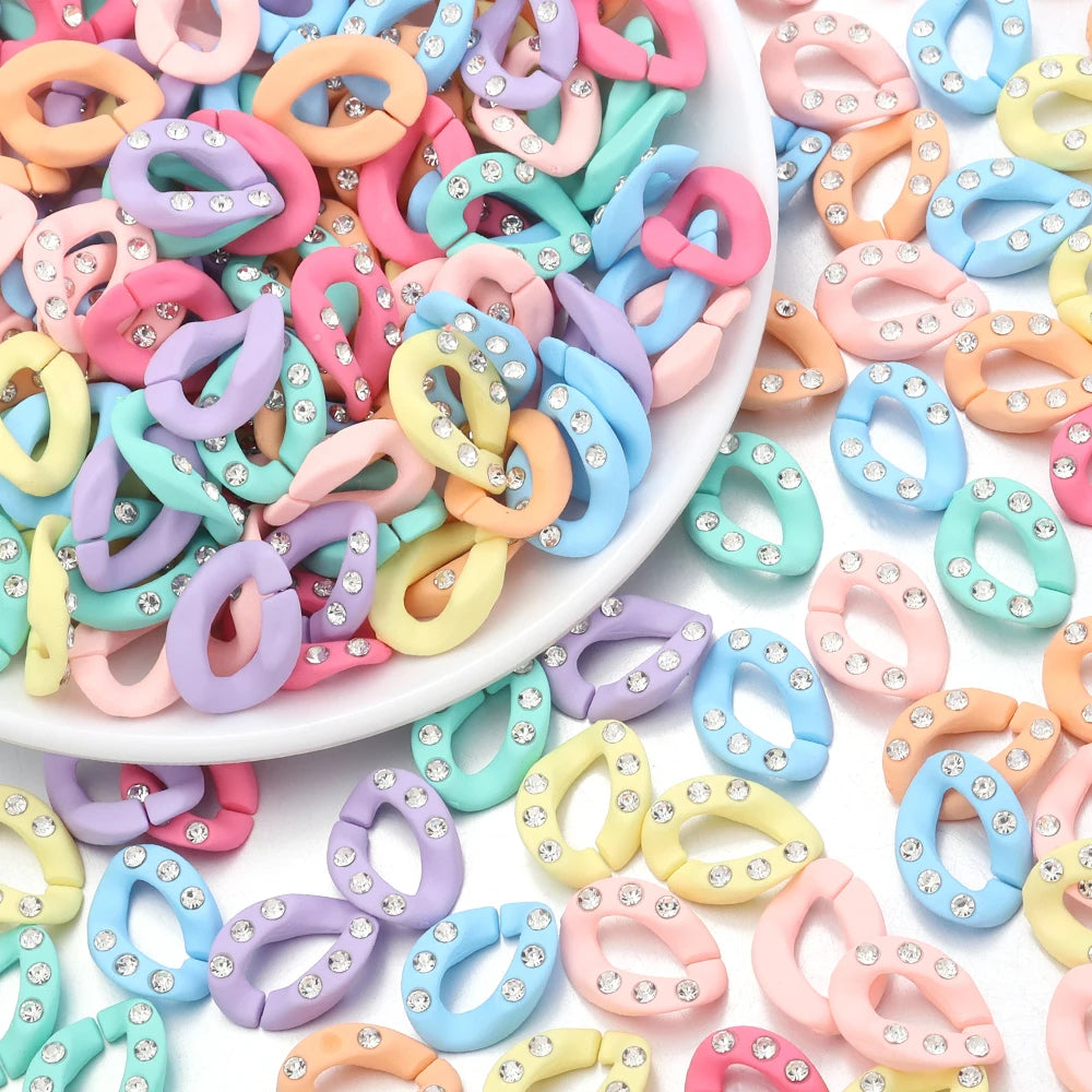 A pile of colorful acrylic link chains in various shades of pink, purple, blue, and yellow for DIY jewelry making.