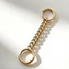 A gold-toned metal chain extender with a circular loop, shown against a white background.