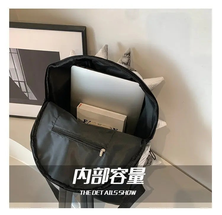 A black hedgehog shaped PU backpack is shown resting on a surface.