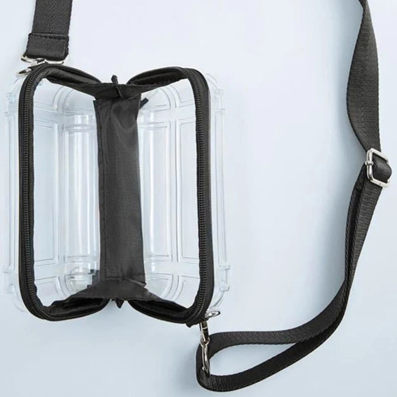 A transparent cosmetic bag with a black strap is shown against a white background.